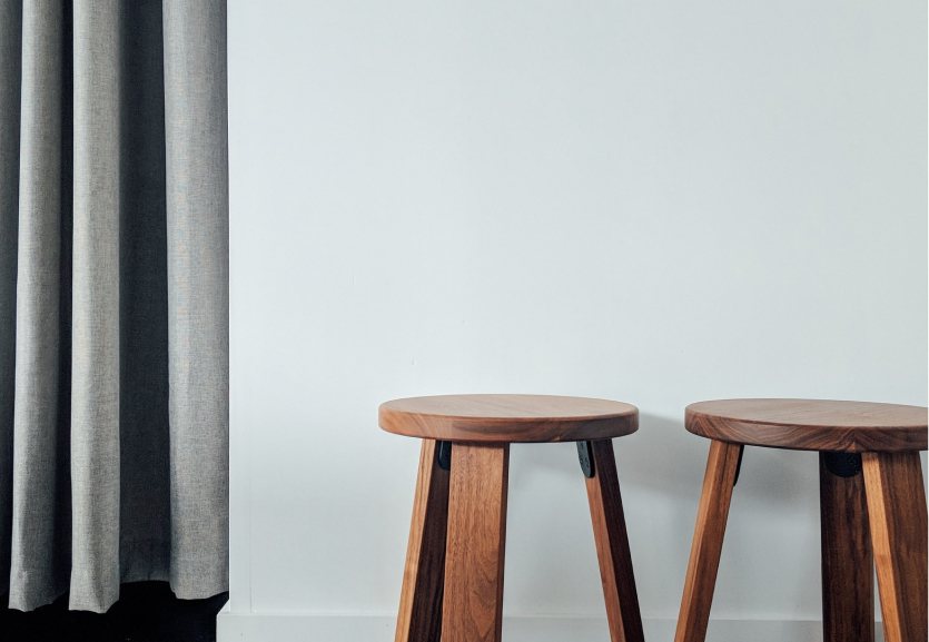 Two wooden stools in a bright room